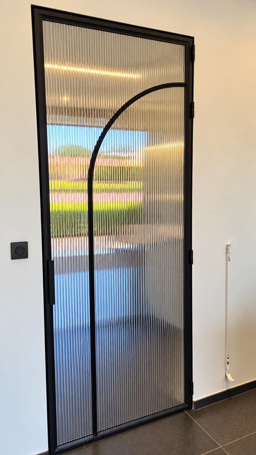 Stalen binnendeur met boogmotief en ribbelglas